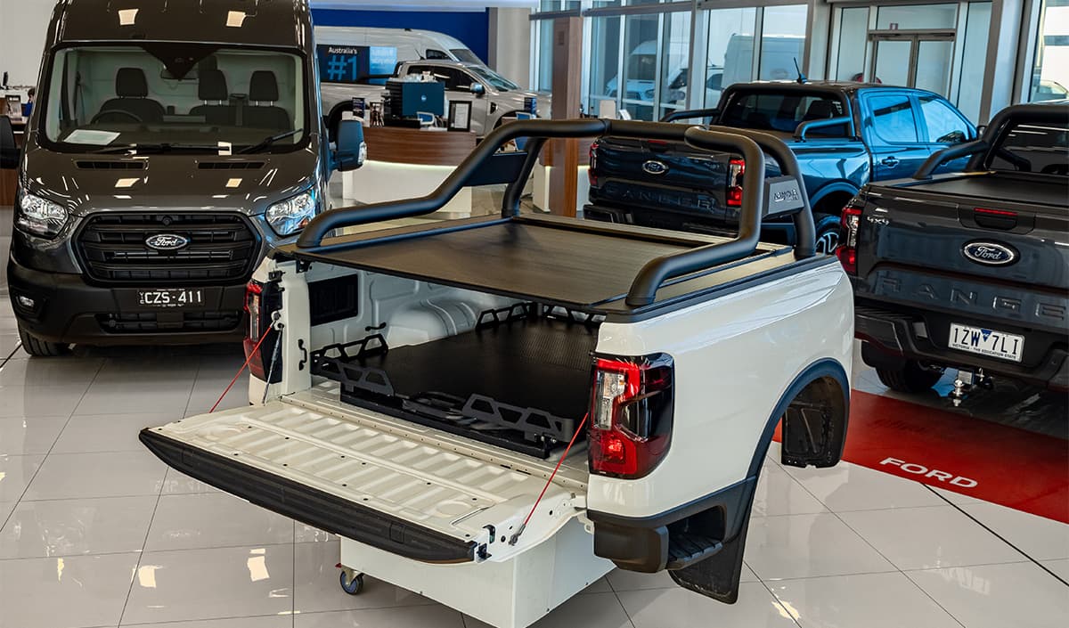 Display tub at dealership featuring ute sports bar, tray slider, and ute roller cover setup for showcasing ute accessory options.