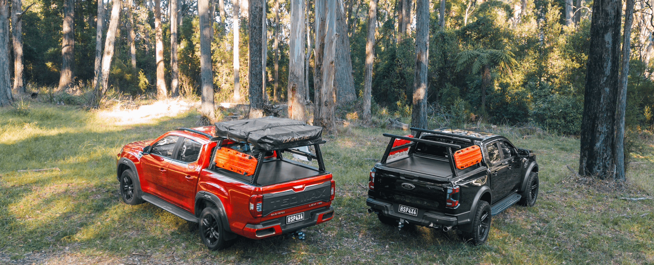 A Showcase of our Ute Ladder Rack with rooftop tent equipped & Ute roller shutter on two dual cab utes in a outdoor offroad setting. Having other various accessories equipped.